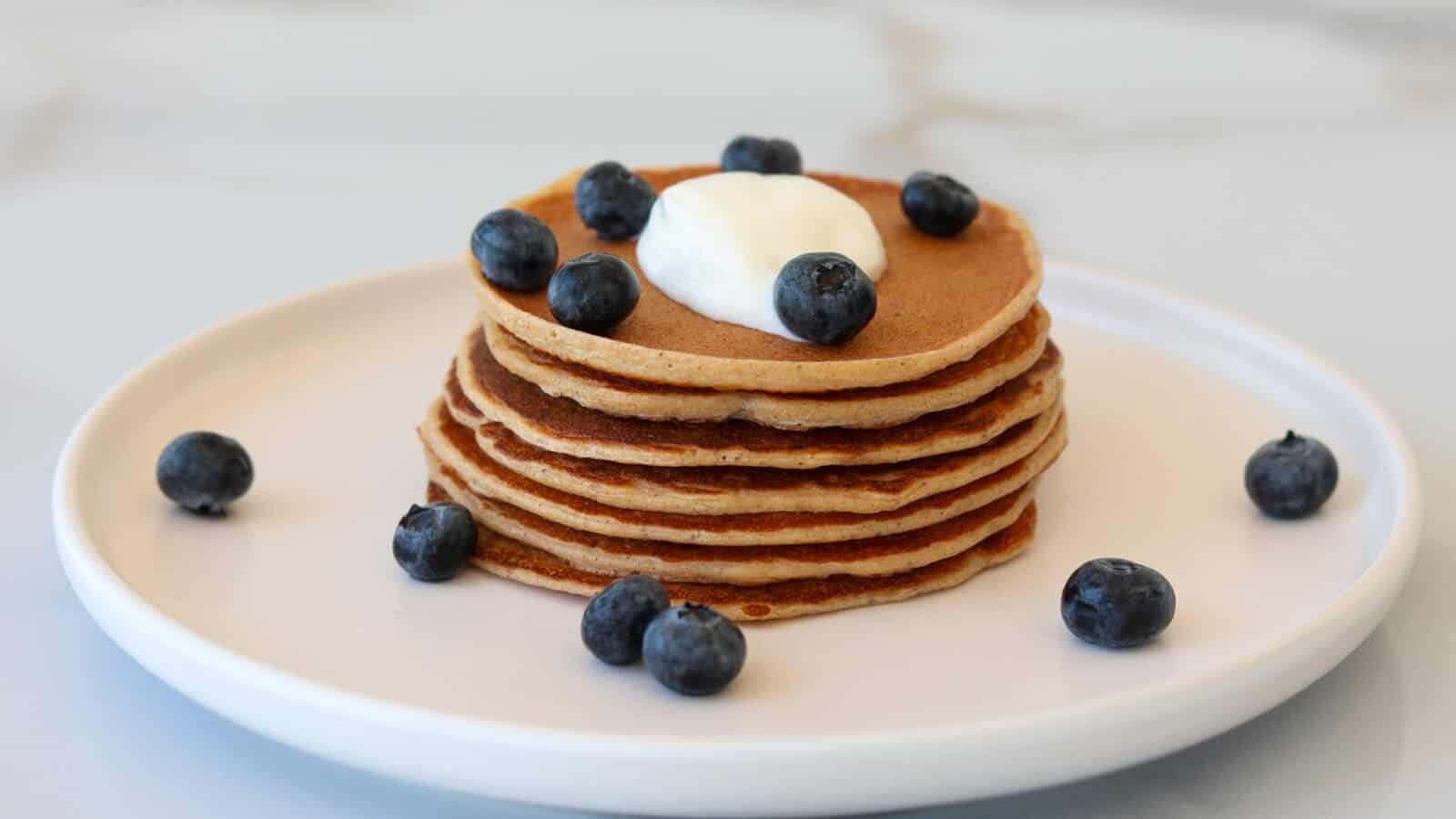 cottage cheese pancakes topped with yogurt and fresh blueberries