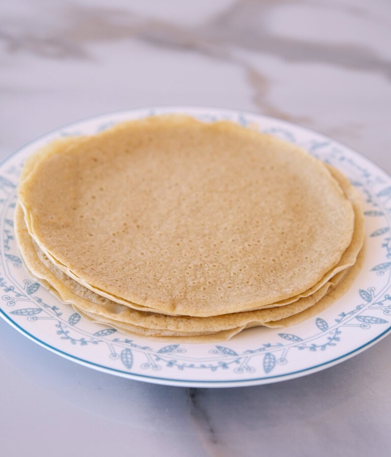 stack of gluten free quinoa crepes on a plate.