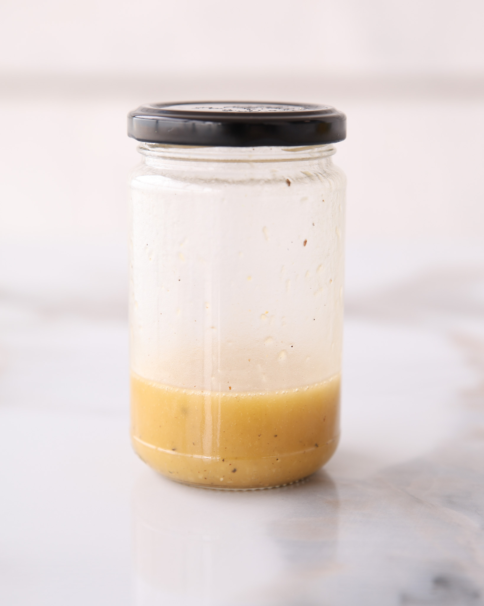 a jar with a vibrant salad dressing