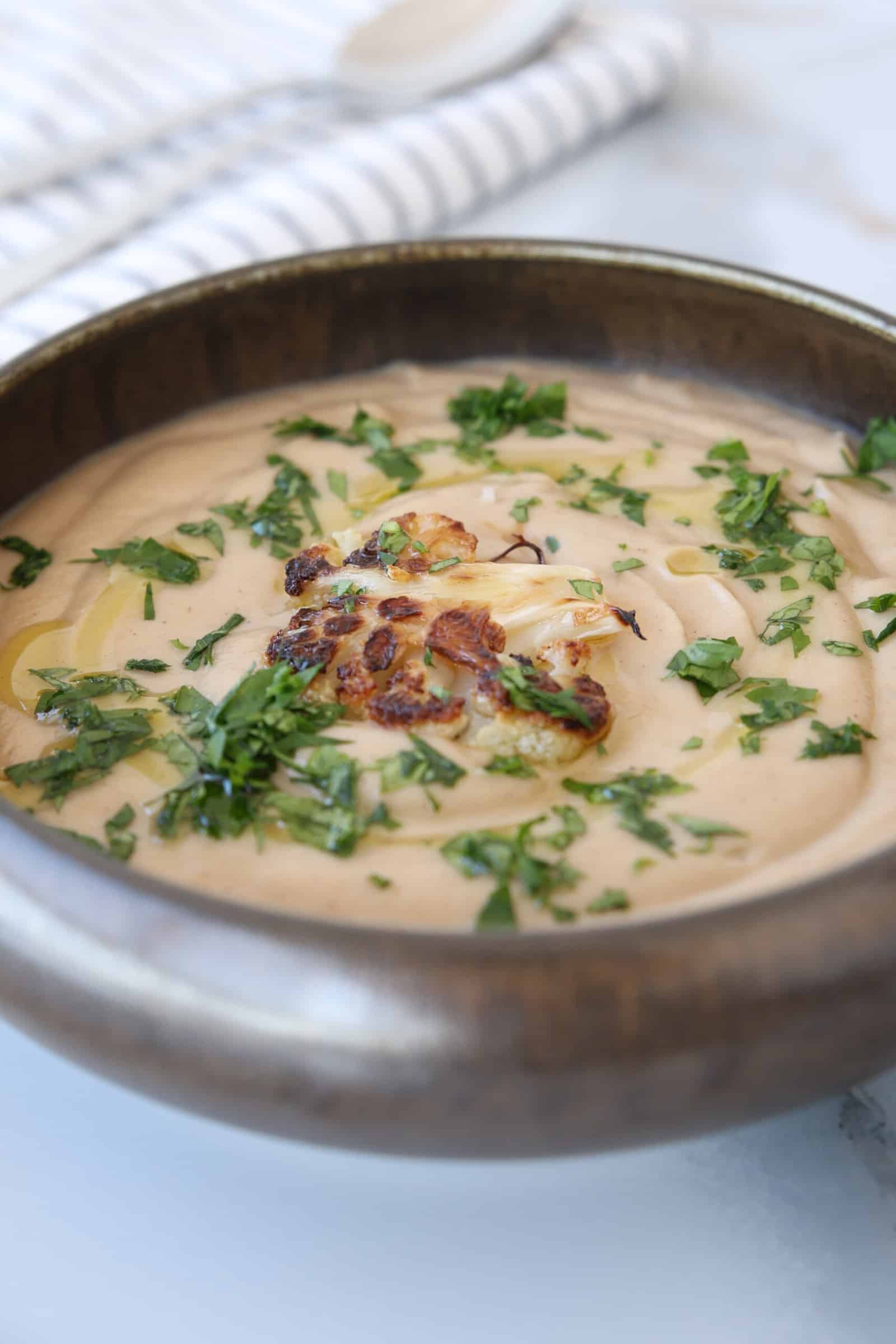 creamy cauliflower soup in a bowl.