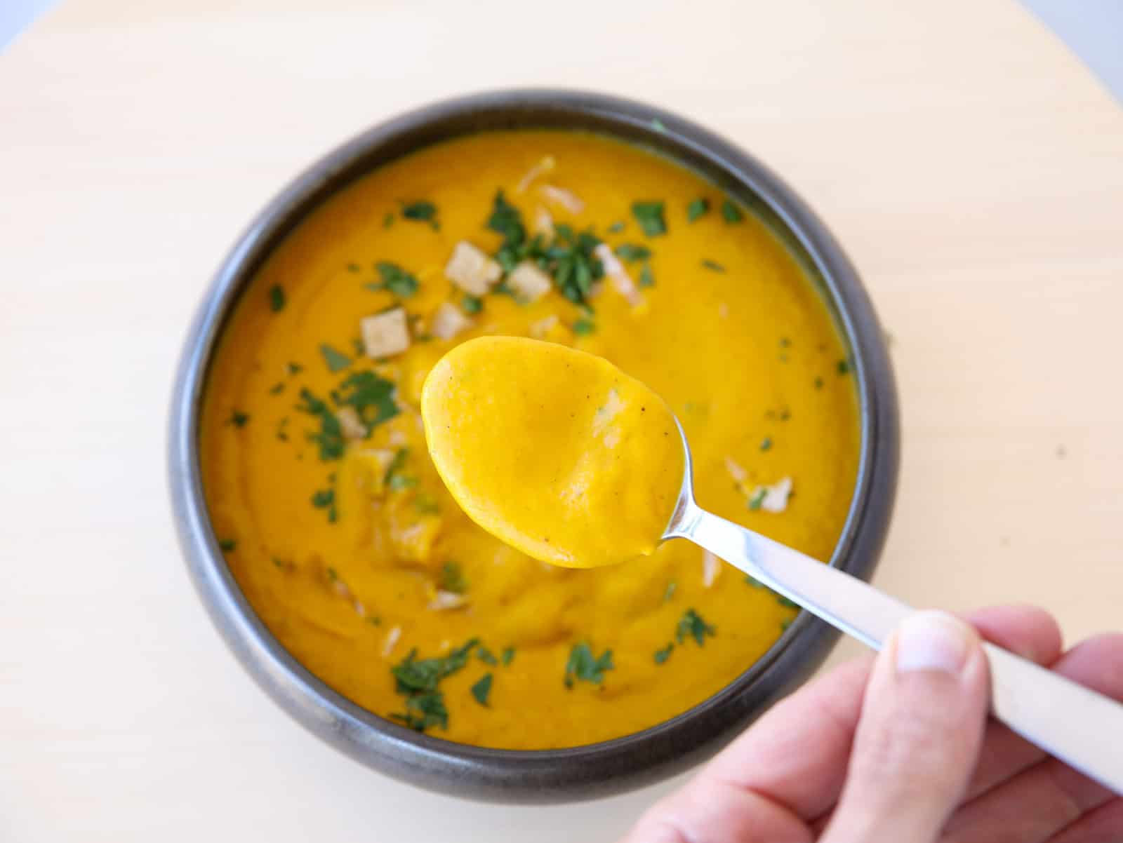 a spoon of carrot and ginger soup