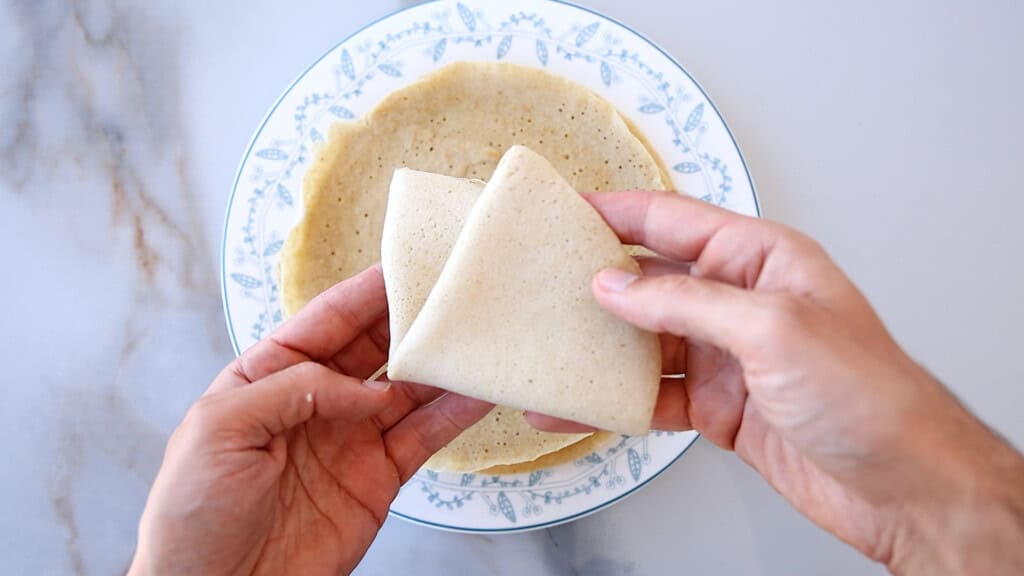 hands holding a folded crepe.