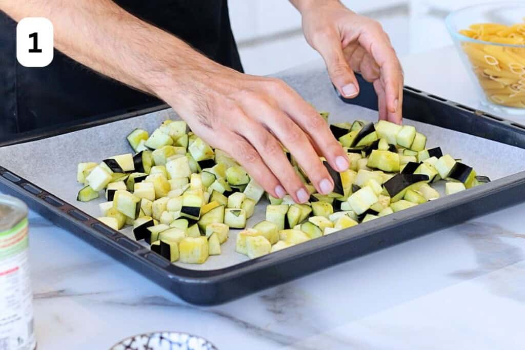 adding the eggplant on a baking sheet to roast.