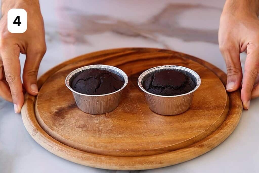 bakes oatmeal chocolate lava cakes on a wooden board.