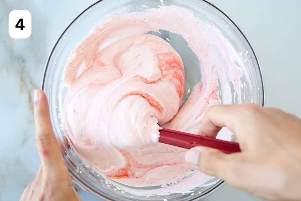 folding the strabwerry puree with whipped cream.