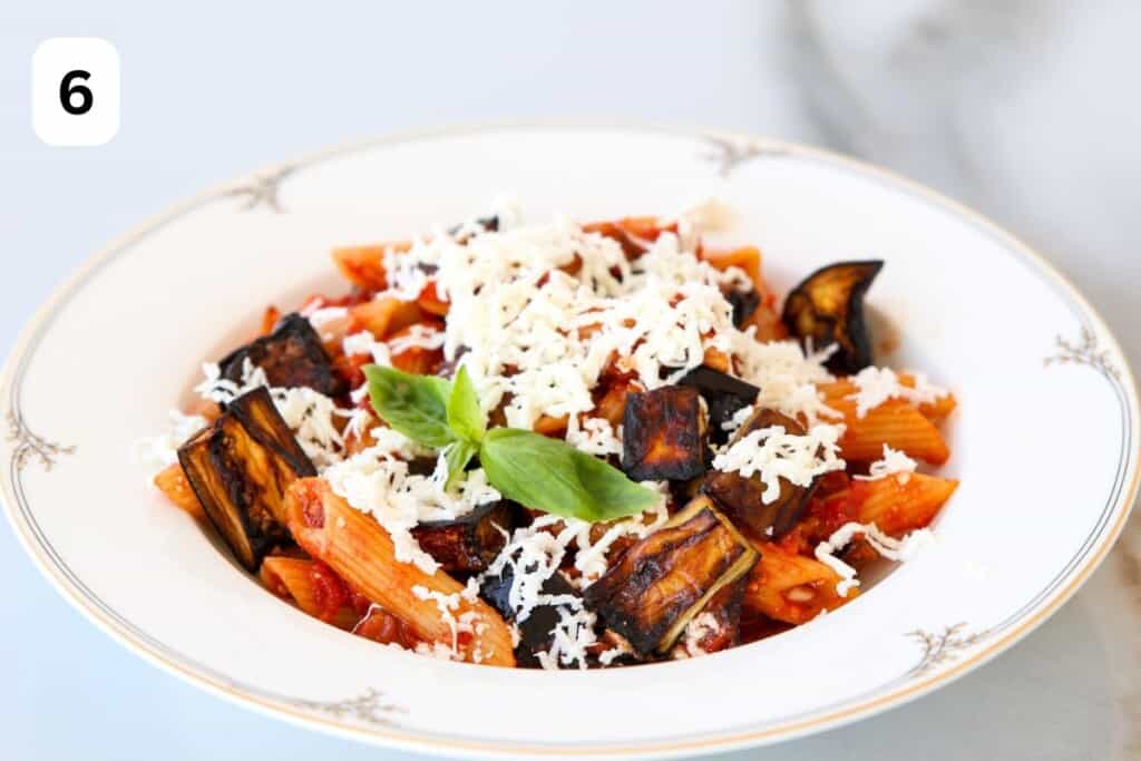 pasta alla norma on a plate topped with ricotta salata.