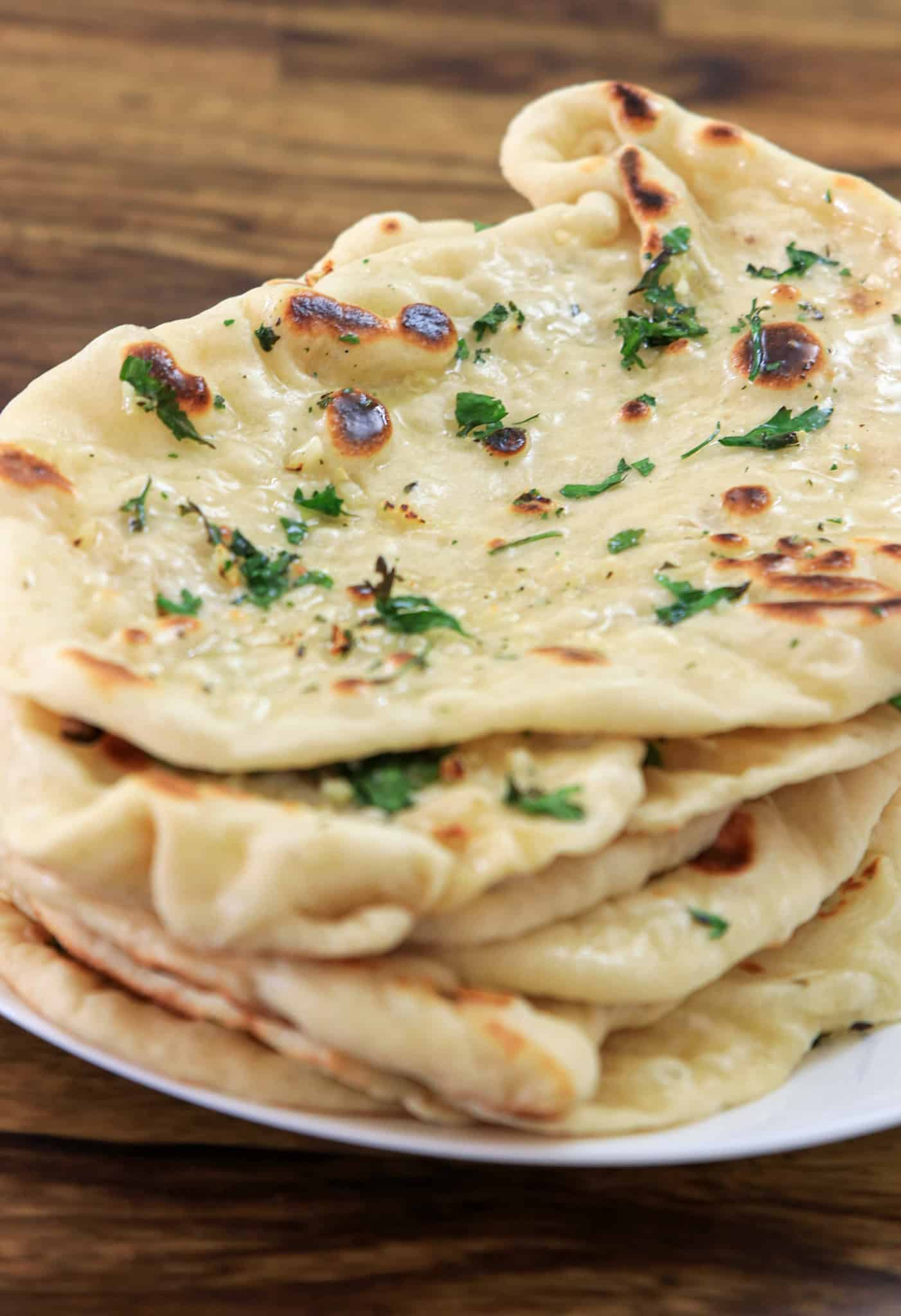 garlic naan breads on a plate.