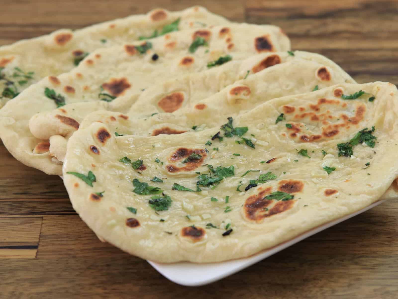 garlic naan breads on a plate.