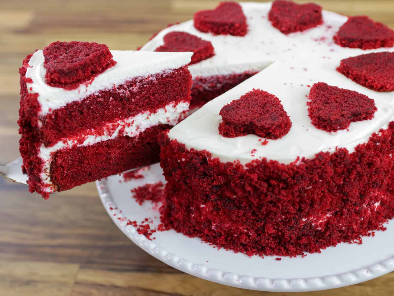 slice cut off of a red velvet cake with two layers