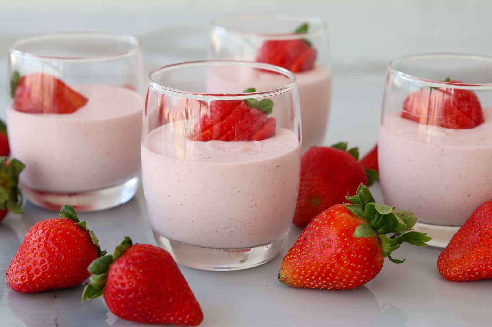 glasses with strawberry mousse and fresh strawberries.