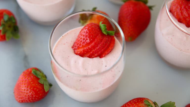 glasses with strawberry mousse and fresh strawberries.