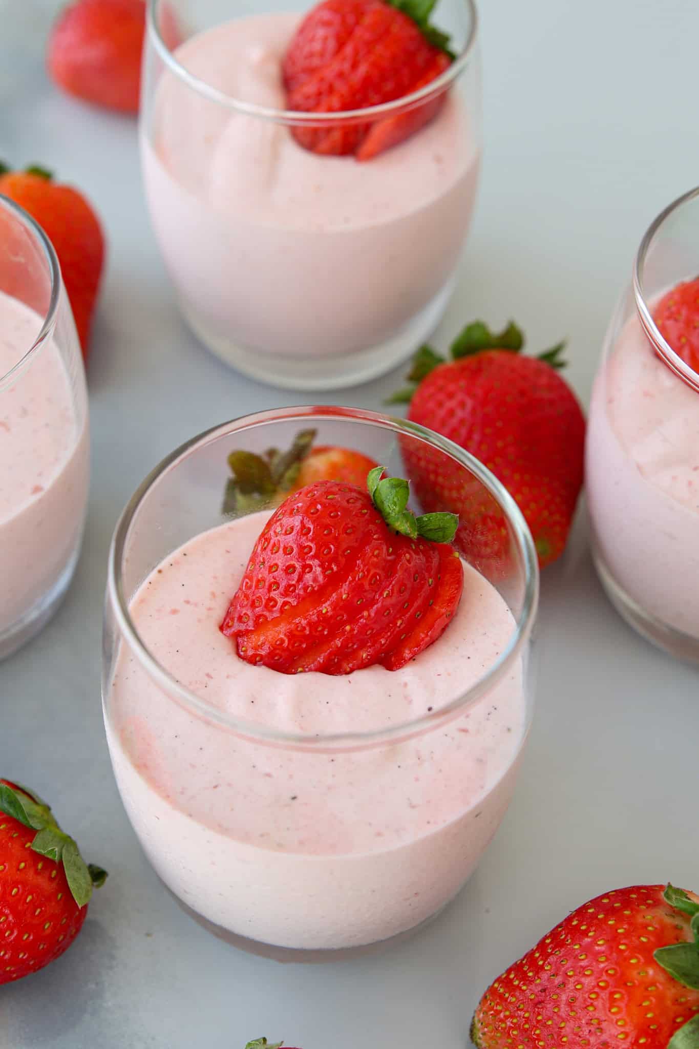 glasses with strawberry mousse and fresh strawberries.