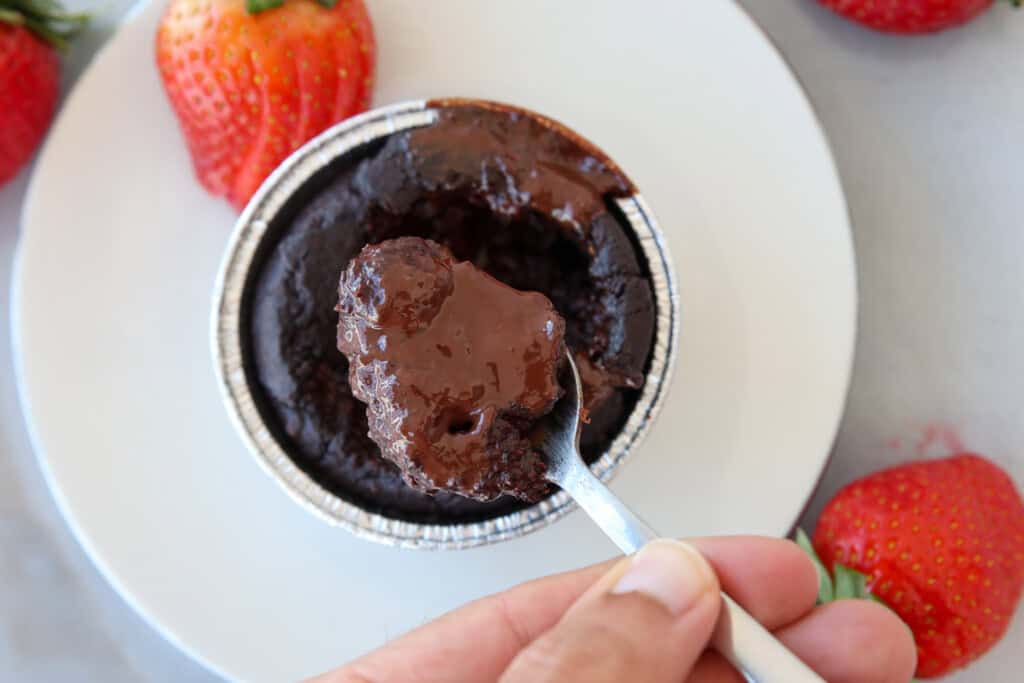 spoon taking a bite of molten chocolate lava cake.