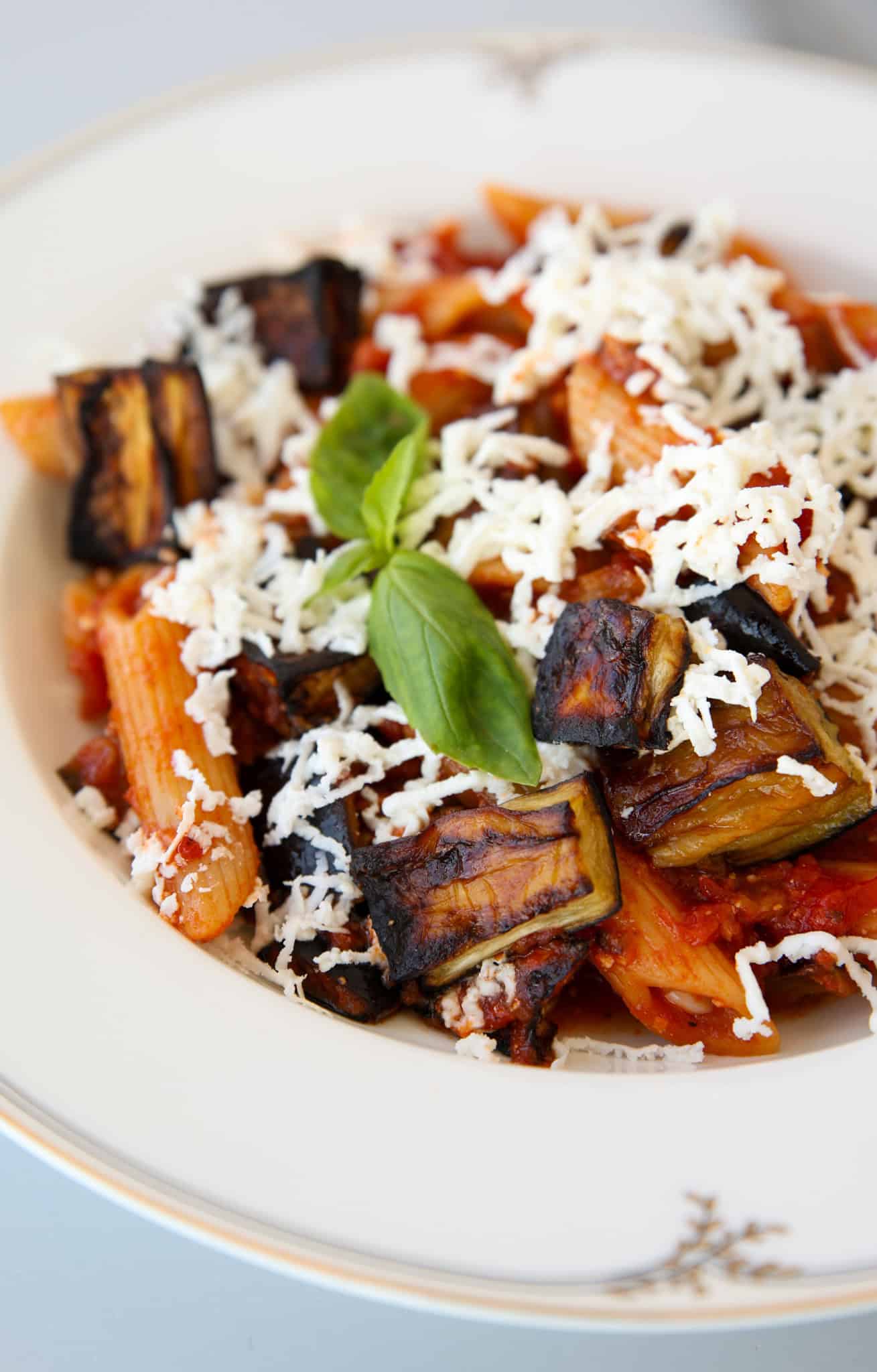 pasta alla norma on a plate topped with ricotta salata.