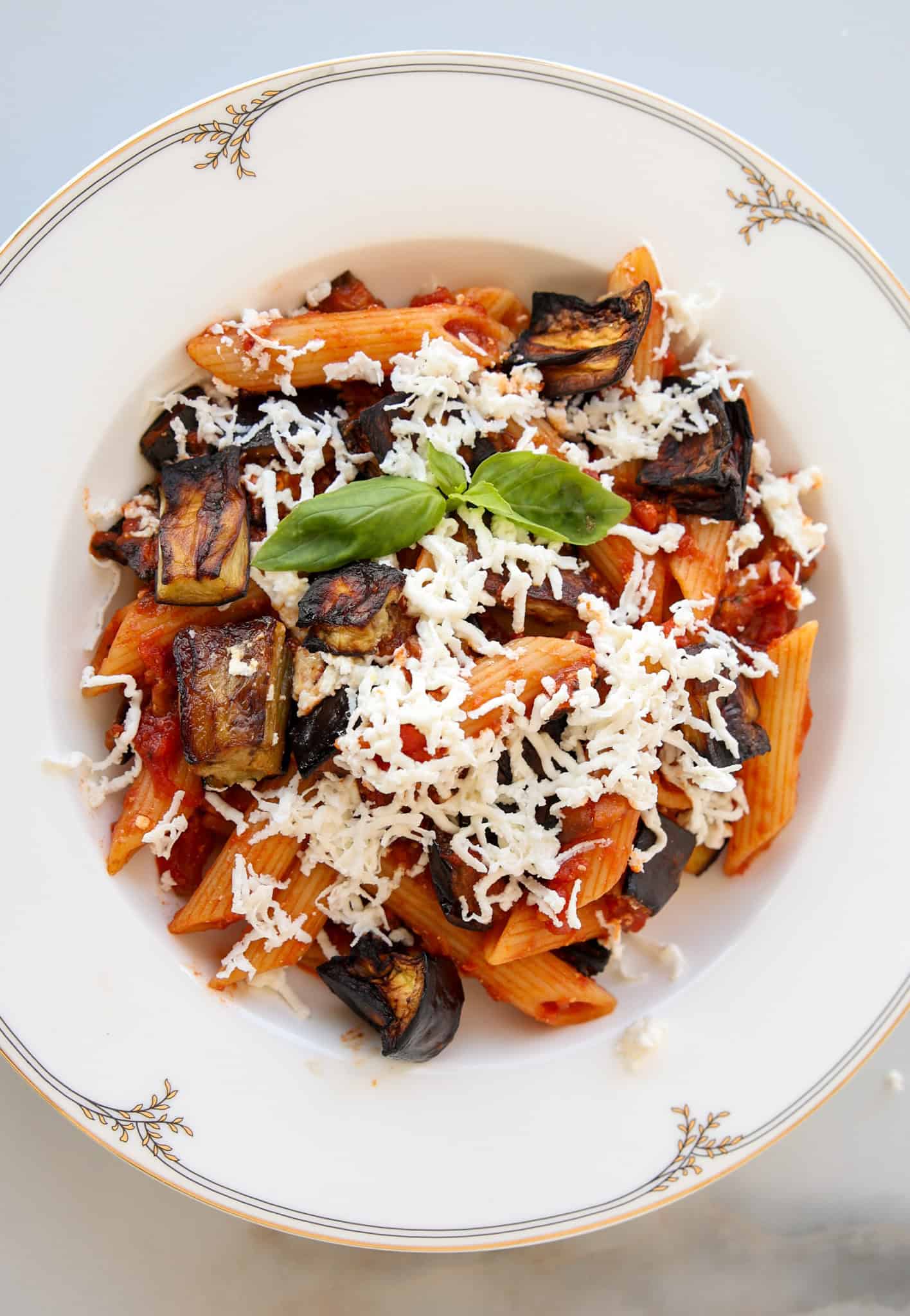 pasta alla norma on a plate topped with ricotta salata.