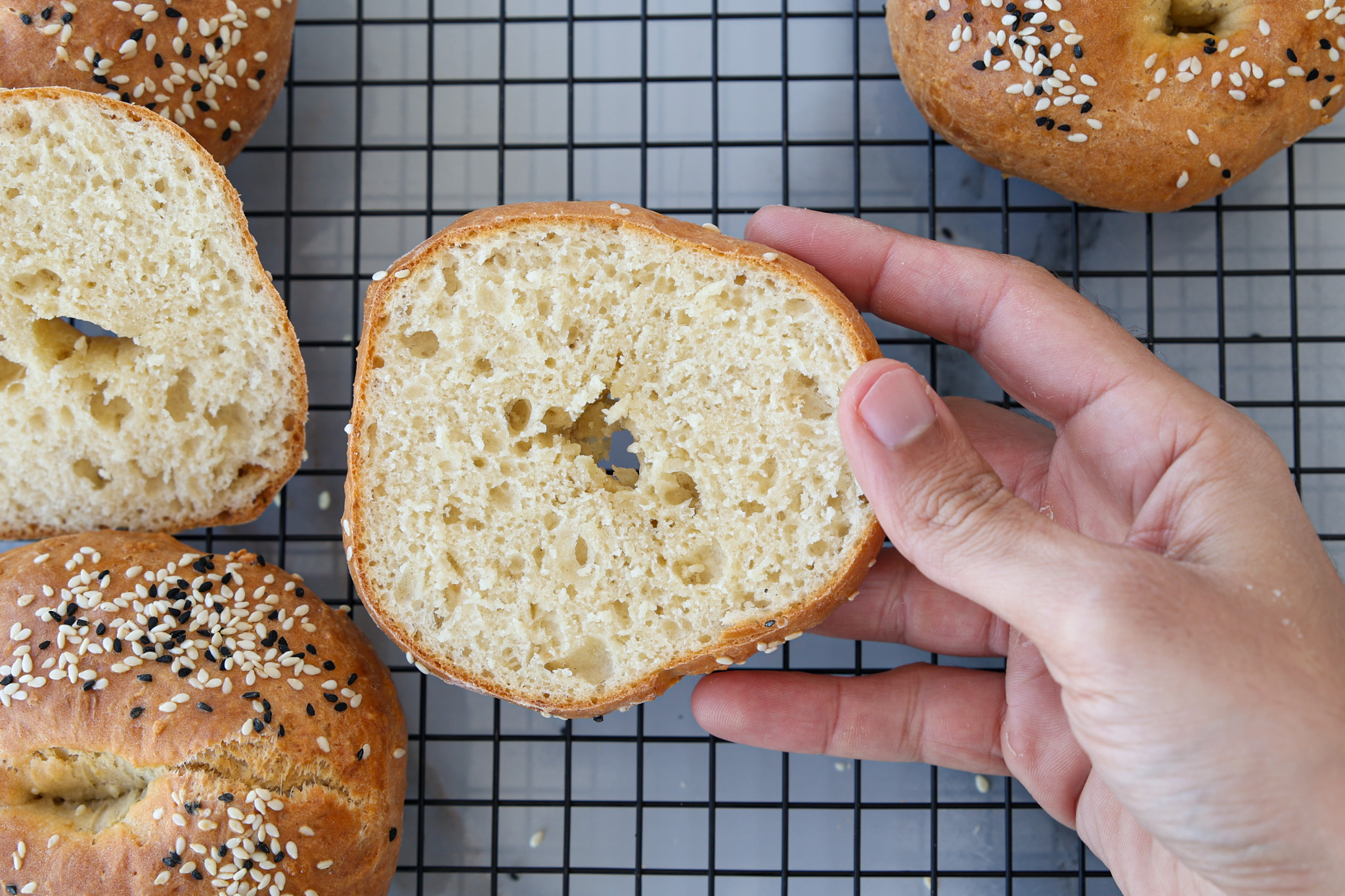 a hand holding soft cottage cheese bagel