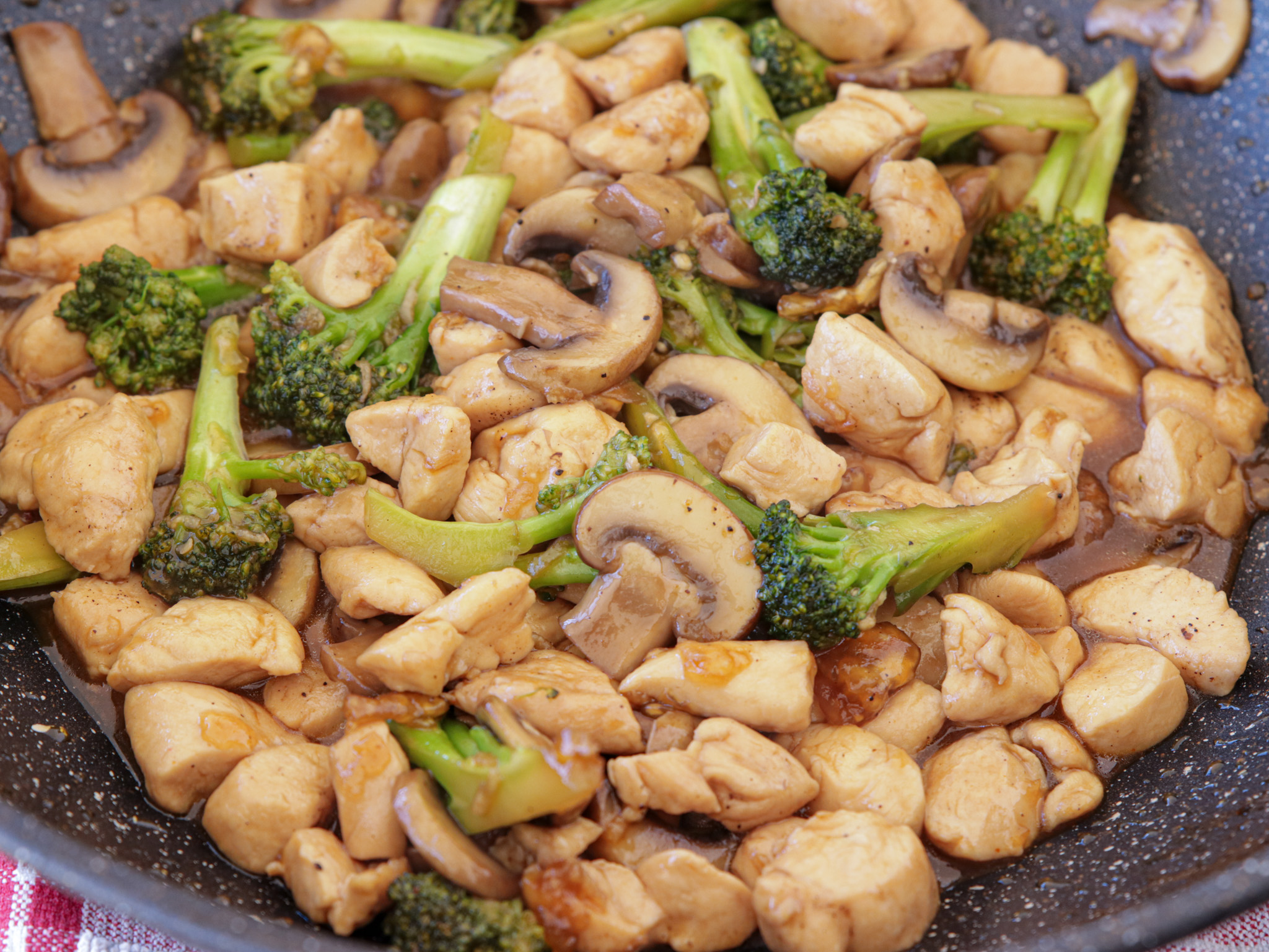 chicken stir fry in a wok with vegetables 