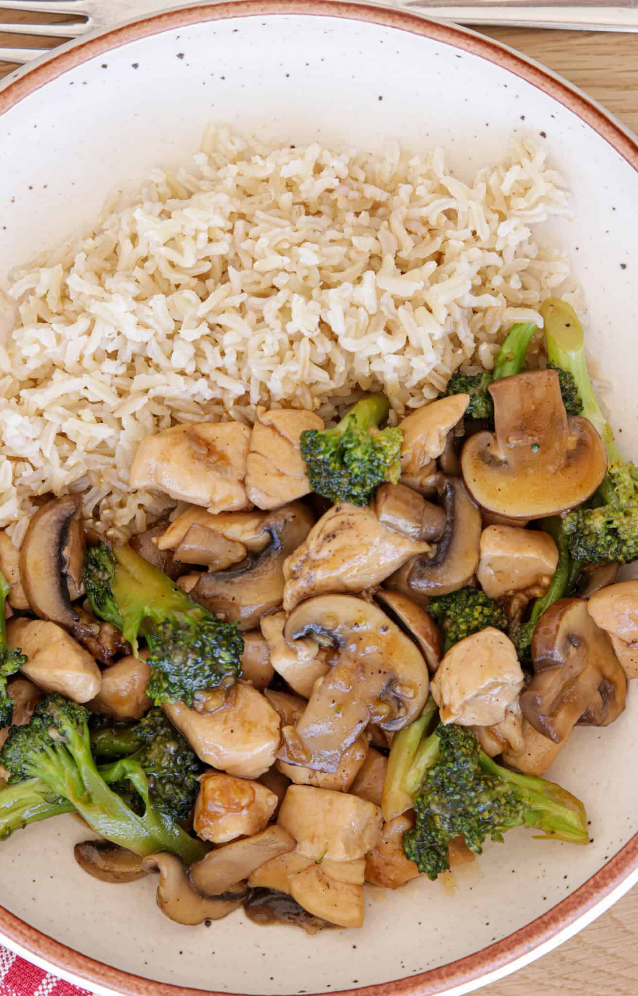 chicken broccoli stir fry on a plate with rice.