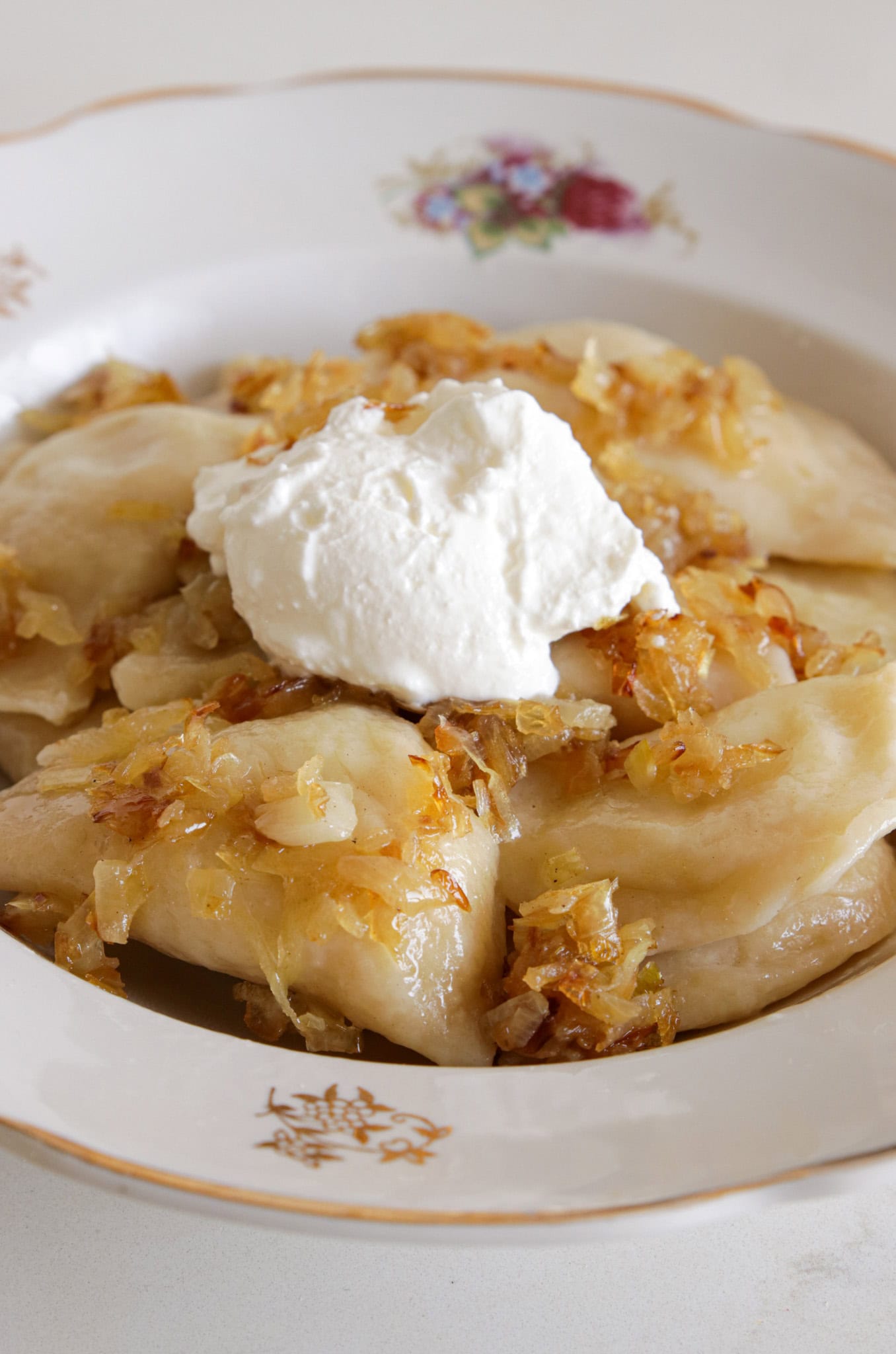 five pieces of Pierogi with sour ceam