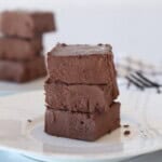 A stack of 3 cottage cheese fudge on a white plate