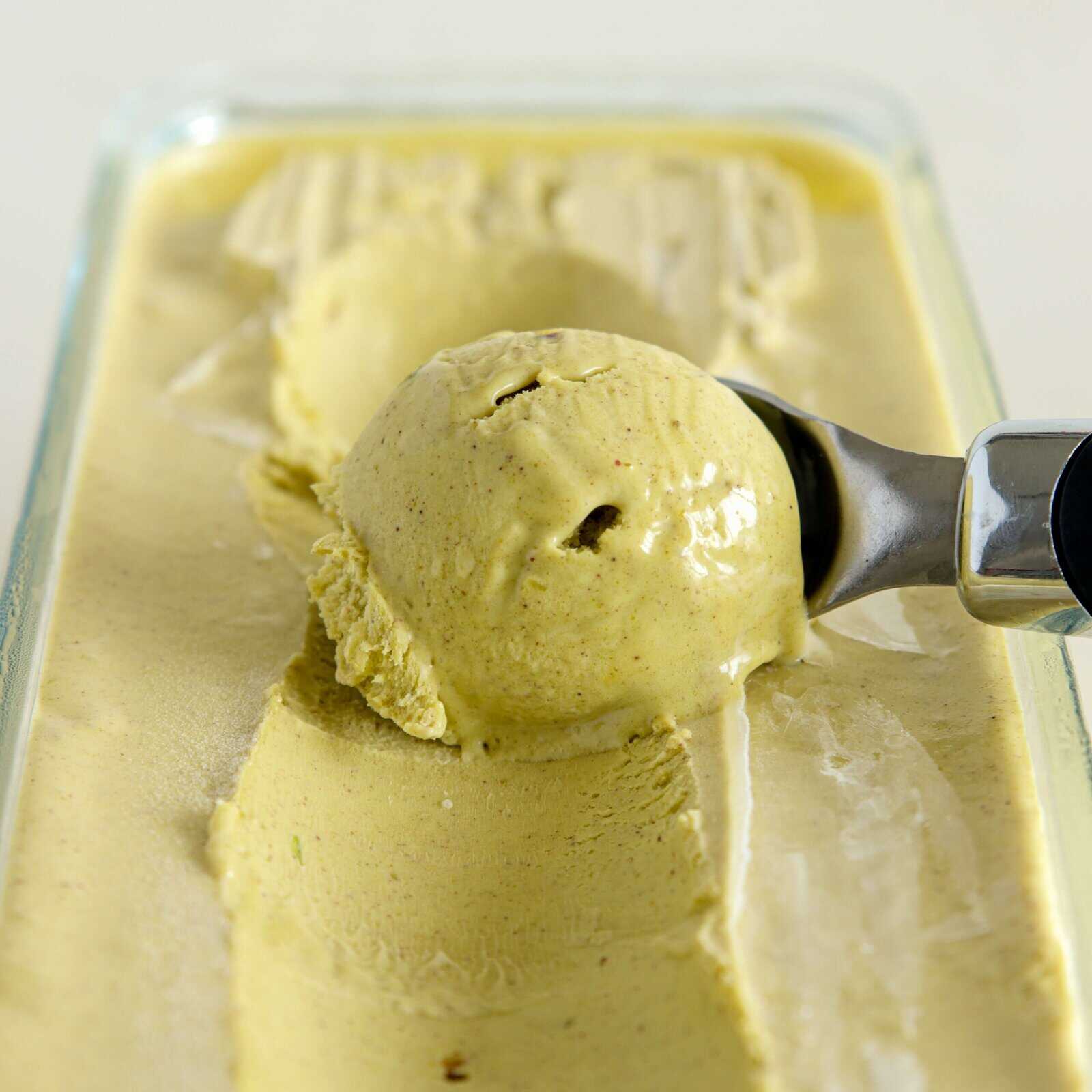 green creamy pistachio ice cream is being scooped