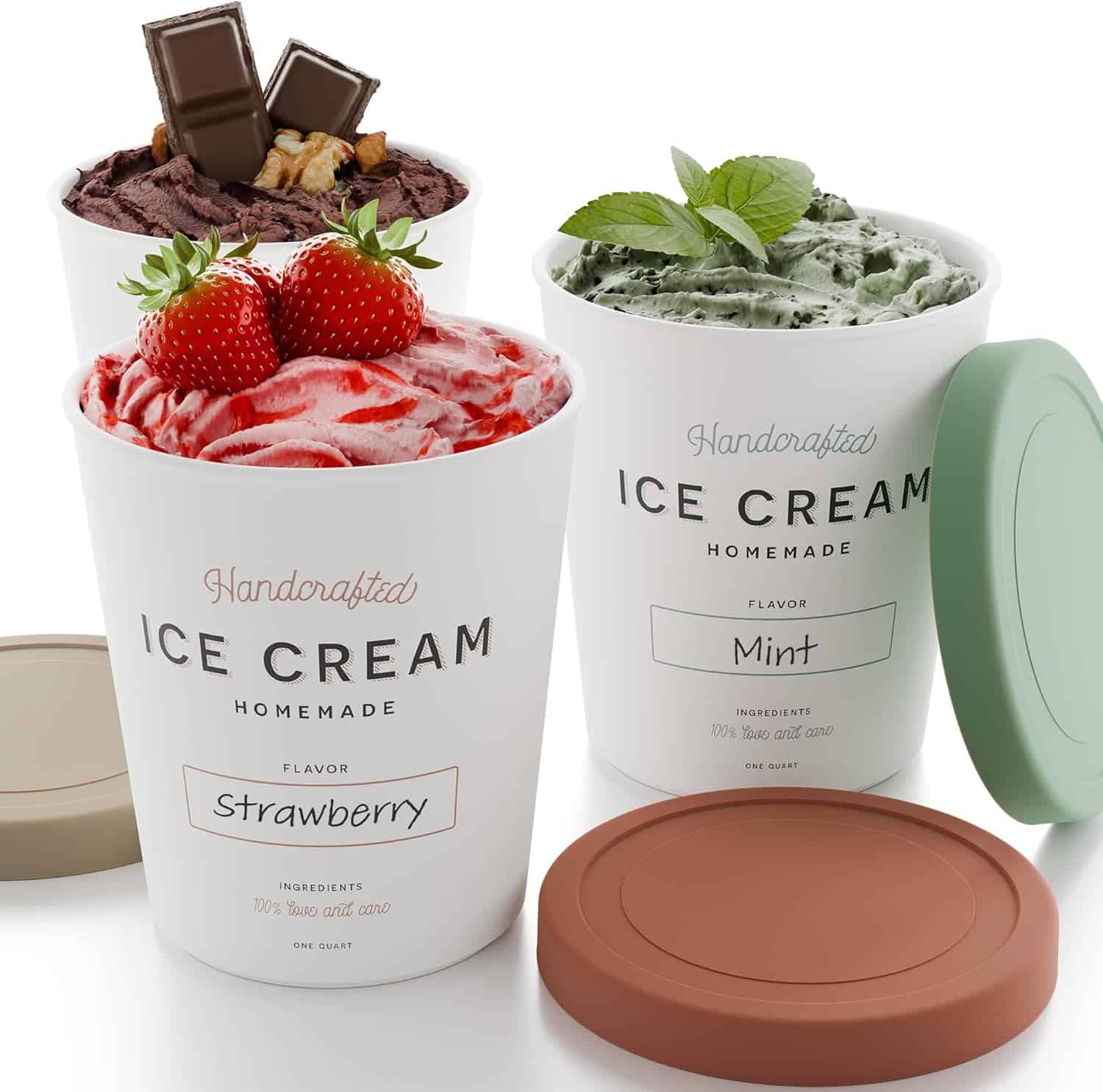 Three pints of handcrafted ice cream: one strawberry with whole strawberries on top, one chocolate with chocolate pieces and nuts, and one mint with fresh mint leaves. Two matching lids are placed nearby.