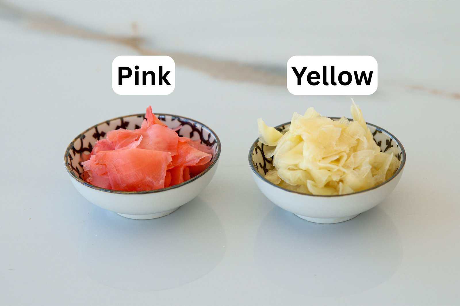Two small bowls on a white surface; the left bowl contains pink pickled ginger labeled "Pink," and the right bowl contains yellow pickled ginger labeled "Yellow.