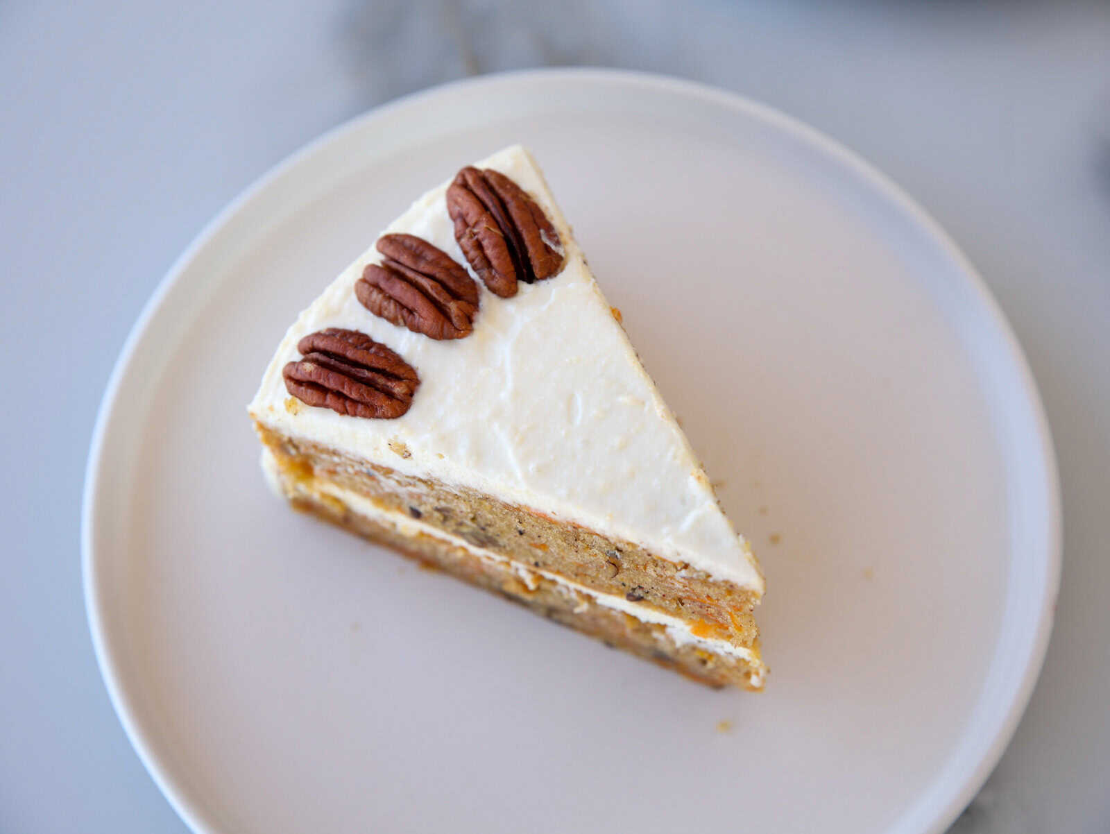 A piece of frosted cake on a plate.