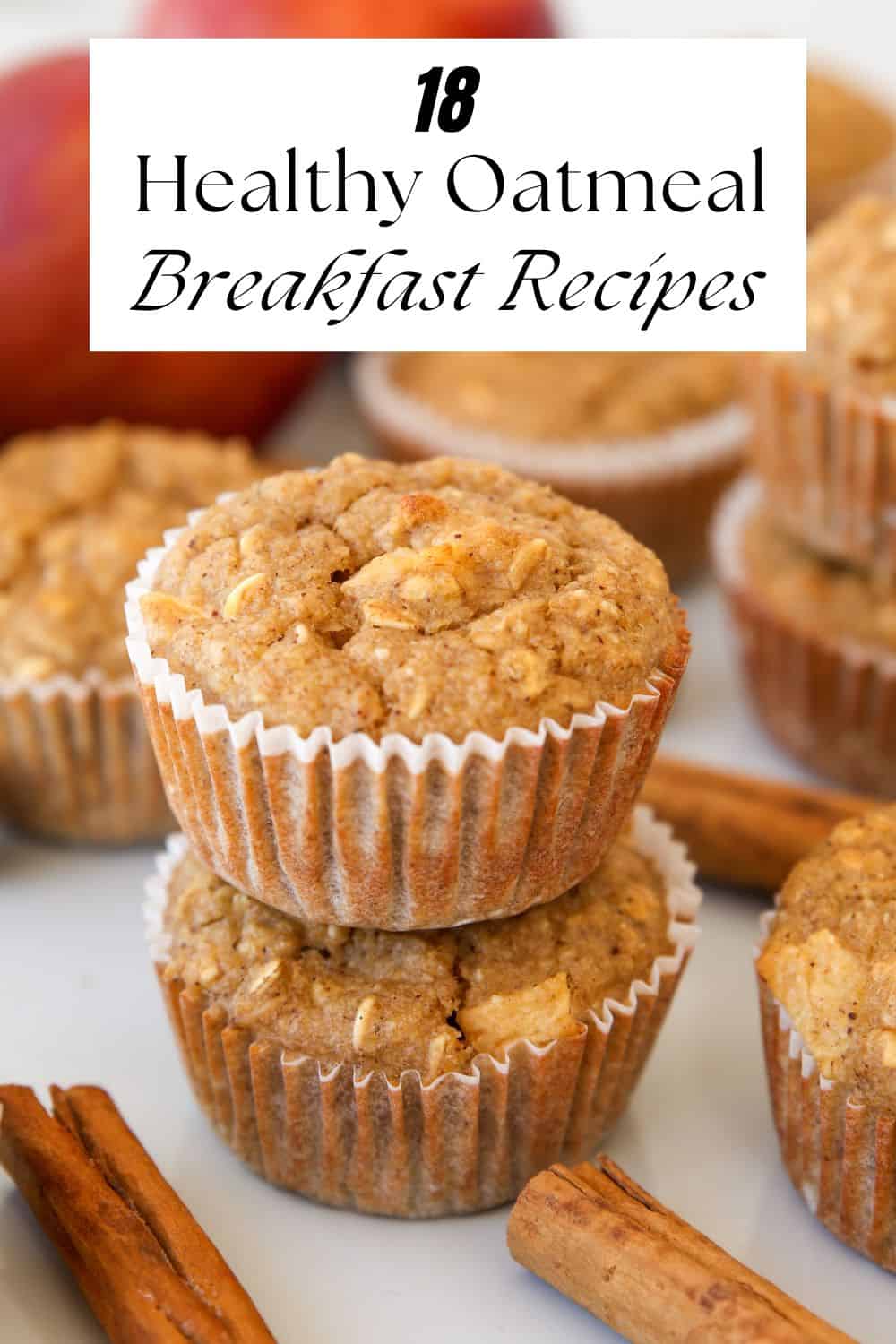 Close-up of oatmeal muffins stacked on a white surface, with cinnamon sticks in the foreground and other muffins in the background. Text at the top reads, "18 Healthy Oatmeal Breakfast Recipes.