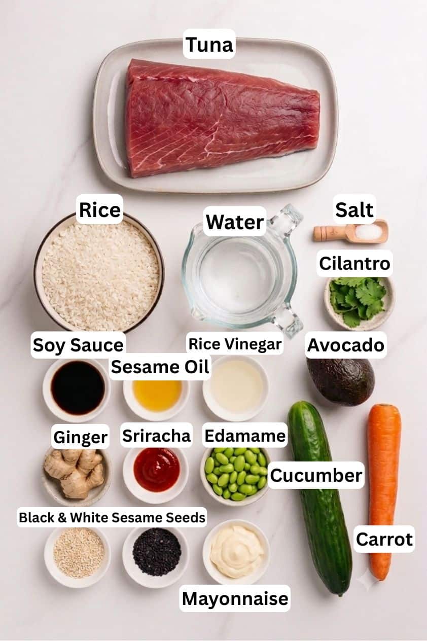 A variety of poke bowl ingredients are arranged on a white surface, including tuna, rice, water, salt, cilantro, avocado, soy sauce, sesame oil, rice vinegar, ginger, sriracha, edamame, cucumber, carrot, sesame seeds, and mayonnaise.
